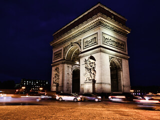 View of famous Arc de Triomphe at night in Paris, France