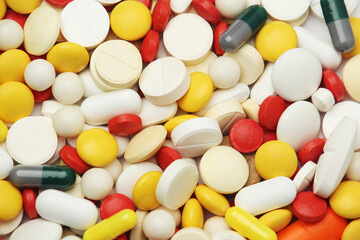 Different colorful tablets at white background
