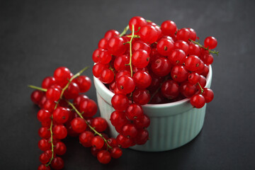 A ceramic bowl with red currant berries