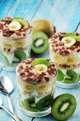 Trifle desserts with bananas, kiwi and yogurt
