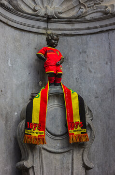 Brussels, Belgium- June 22, 2014: A picture of the Manneken Pis dressed as a football player.