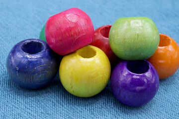 colorful wooden beads on a blue background