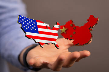 usa and china maps in hand