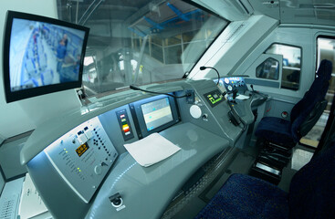 Empty cabin of the passenger train, dashboard, seats, monitors, speedometer, start lever
