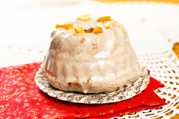 Christmas cake kuglof with white glaze topping, beautifully decorated red green nutcracker