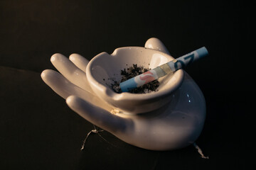 Conceptual photo of Mexican money being used as tobacco cigars