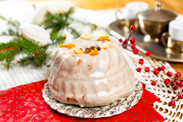 Christmas cake kuglof with white glaze topping, beautifully decorated red green nutcracker