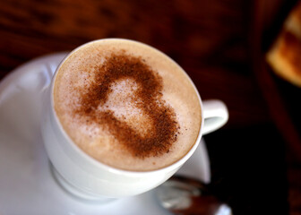 Photo of delicious coffee with a heart pattern cappuccino