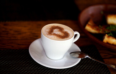 Photo of delicious coffee with a heart pattern cappuccino