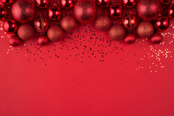 Layout celebrate Christmas seasonal backdrop texture concept. Close up overhead view photo of beautiful luxury handing balls shiny serpentine on bright color red background with blank empty space