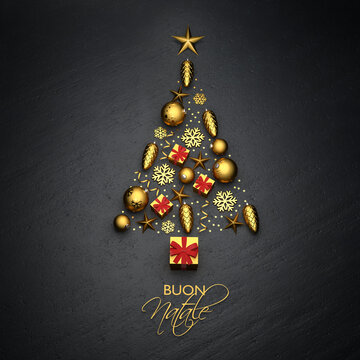 A christmas tree made from golden christmas ornaments lying on a black stone plate. Italian Text "Buon Natale" ("Merry Christmas") on the bottom.