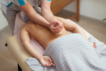 Fototapeta na wymiar Caucasian woman getting a spine massage in the spa salon. Body care concept.