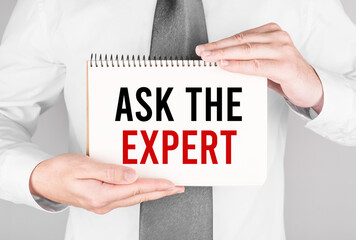 Businessman with notebook with text Ask the Expert
