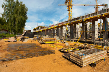 reinforced frame of a new monolithic house under construction against the blue sky
