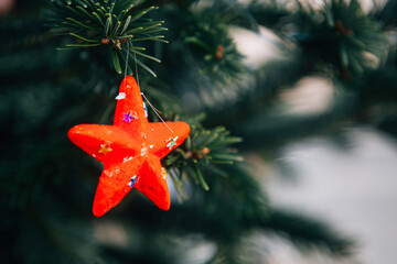 Christmas decoration on a branch of a live fir tree in the midst of the holiday