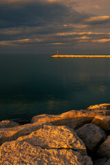 An harbor lighthouse in Rimini at sunset, Italy