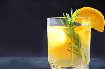 glasses of honey bourbon cocktail with rosemary whiskey sour drink with orange peel, or winter...