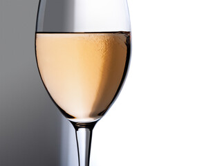 Wine glass isolated. Transparent glass with white wine isolated against white and grey sharp gradients background