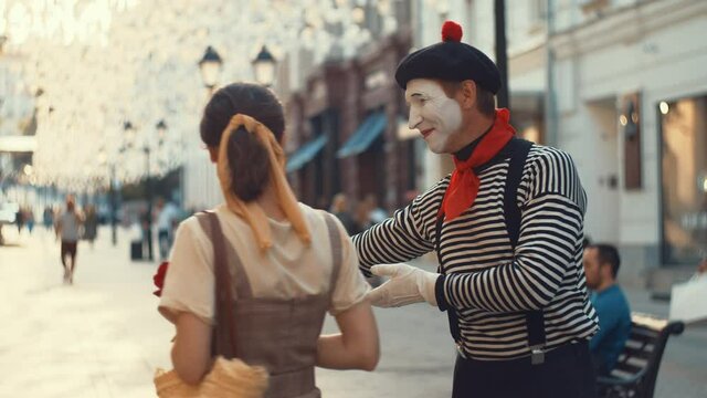 Attractive girl with mime on the street in summer
