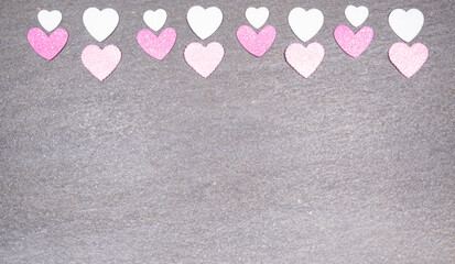 gray granite background with pink and white hearts for valentines day. Valentine's day and love concept