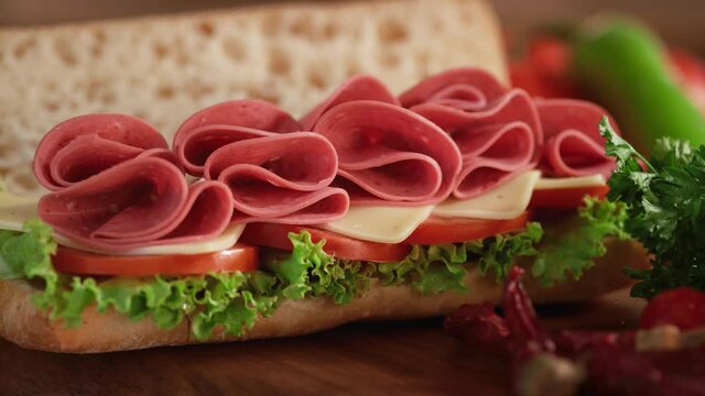Beef salami sandwich with served on a dining table. Slow motion 4K video.
