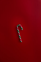 Christmas candy cane on red background