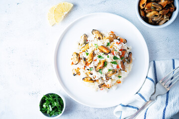 Mussel rice with pepper and parsley in a plate