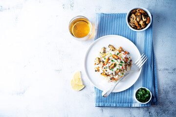 Mussel rice with pepper and parsley in a plate