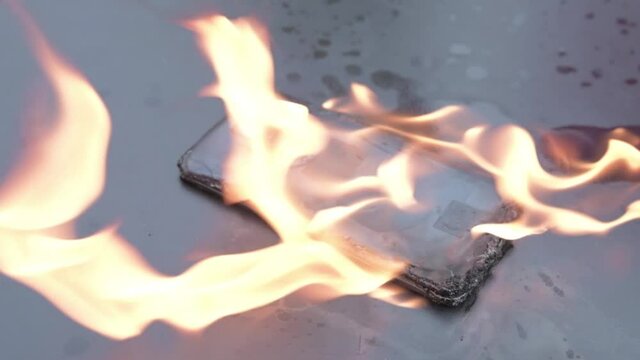 Mobile phone explodes and burns. Cell Phone explosion and fire .Smart Phone Danger from over use or bad manufacturing. Burning up my phone concept.