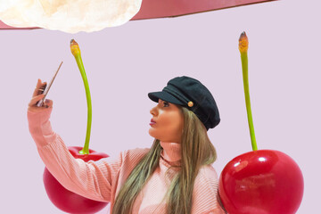 young woman in hat making a selfie with giant cherries