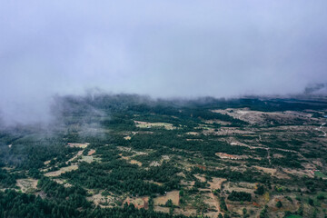Flight through the clouds, drone view from above. Autumn valley.