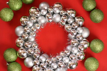 Wreath on red background. New Year's wreath. Christmas decorative toys. Christmas, winter, new year concept. Flat lay, top view, copy space.