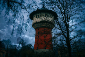 Abandoned gothic-style water tower in the gloomy city.