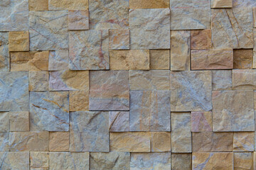 pattern brown color of old stone marble wall uneven cracked real stone wall surface with cement