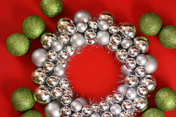 Wreath on red background. New Year's wreath. Christmas decorative toys. Christmas, winter, new year concept. Flat lay, top view, copy space.
