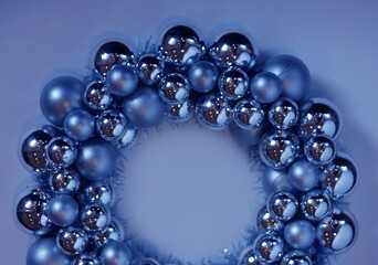 Wreath on blue background. New Year's wreath. Christmas decorative toys. Christmas, winter, new year concept. Flat lay, top view, copy space.