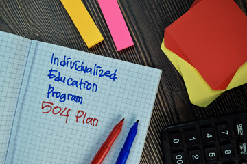 Individualized Education Program 504 Plan write on sticky note isolated on Wooden Table. Financial Concept