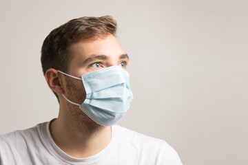 Boy with face mask to protect himself from viruses and bacteria looking aside