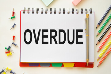 overdue invoices concept. the word expired written in a notebook with pencils