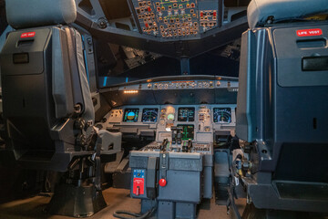 modern airplane cockpit  in a full flight simulator - a state of the art training device  - obrazy, fototapety, plakaty