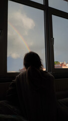 Girl and rainbow at home