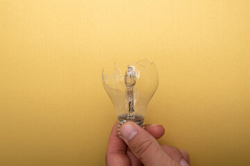 broken idea lamp on gold background