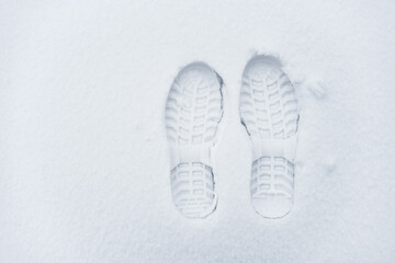 Imprint of shoes in the snow. Single clearly defined footprint of a shoes in snow.