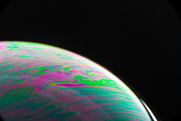 Brightly Colored Macro Bubble on Black Background