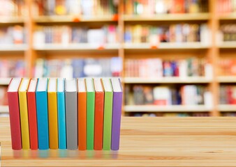 Stack open old books on wooden desk