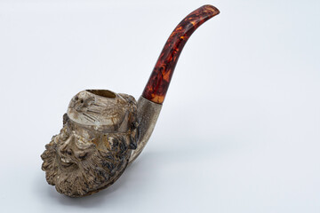 old smoking pipe with a hand carved head