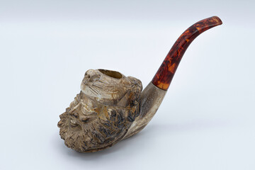 old smoking pipe with a hand carved head