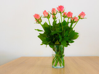 Bunch of salmon colored roses in a vase
