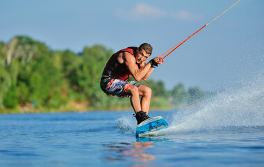 Wakeboarder surfing across a lake