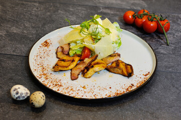 Delicious, beautiful, fresh salad in a plate on a wooden restaurant table